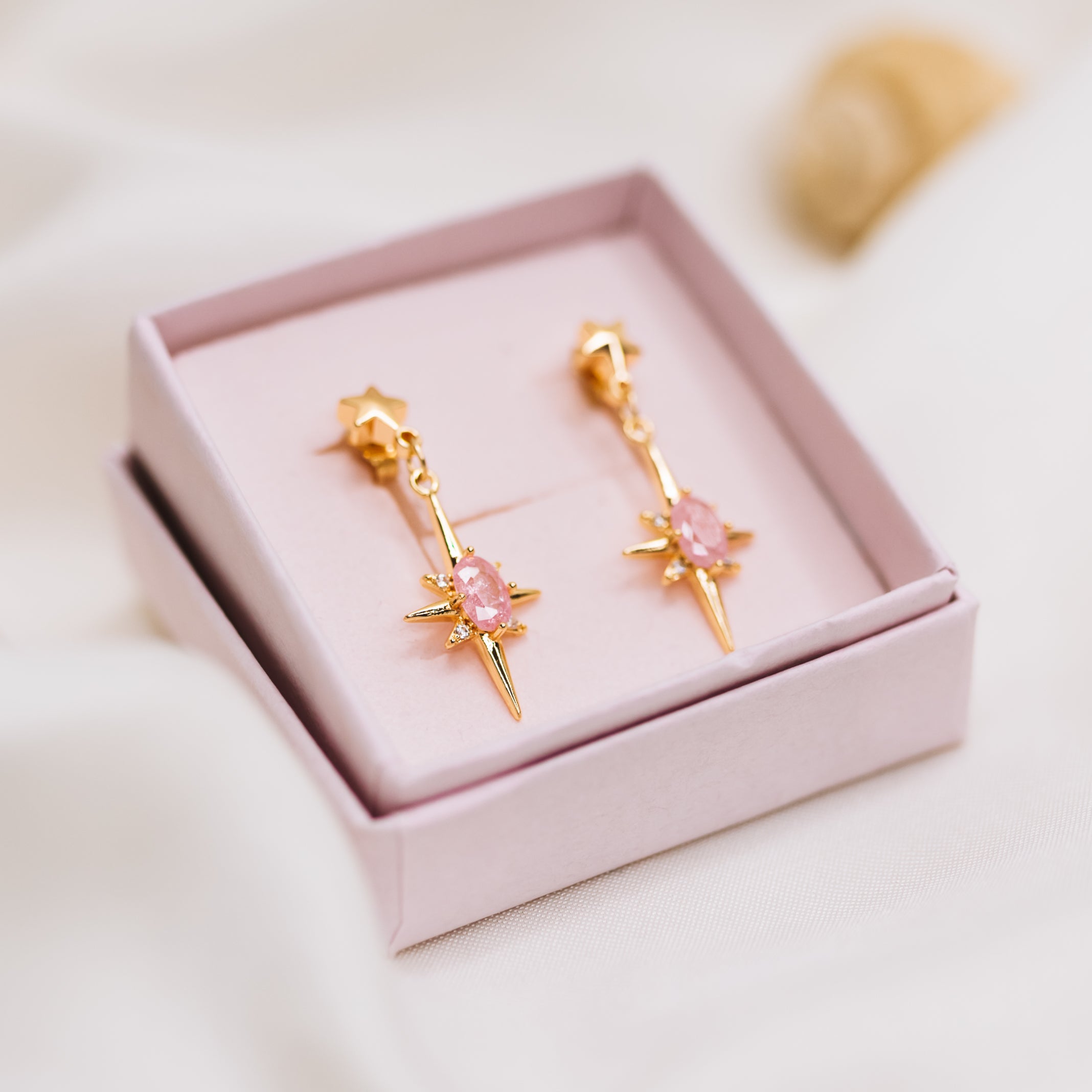 Gold celestial star earrings with pink zirconia drop star in pink Phoebe Lune box